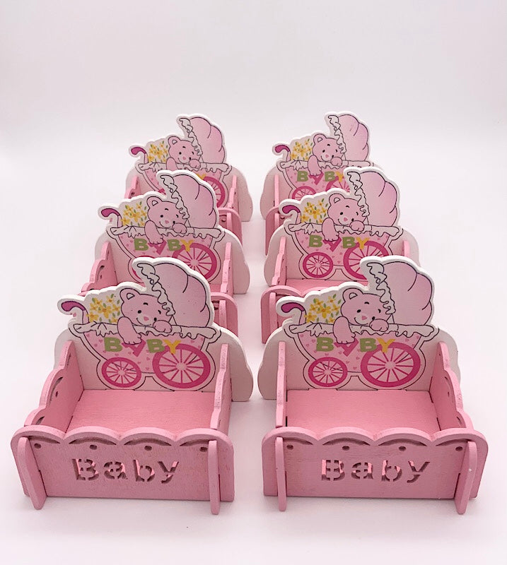 Set of pink baby shower treat boxes featuring baby girl-themed designs.