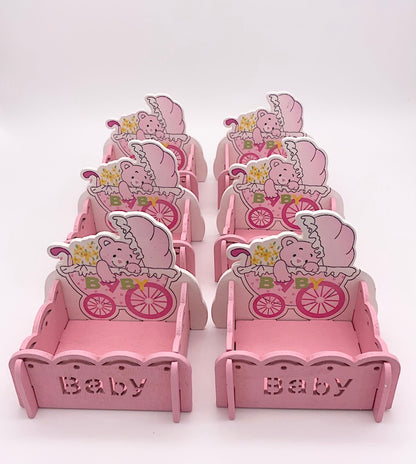 Set of pink baby shower treat boxes featuring baby girl-themed designs.